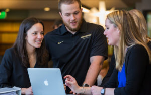 The Vanderbilt Master of Marketing program prepares students from all majors for a career in marketing. This photo shows 3 students working together on a project.