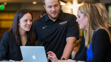 The Vanderbilt Master of Marketing program prepares students from all majors for a career in marketing. This photo shows 3 students working together on a project.