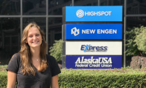 Kirstin Johnson (MMark'18) in front of New Engen Logo
