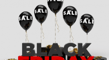 Pictured: A retail display with "Black Friday" in black and red letters. Above the letters, there are black balloons with "sale" in white. Displays like this are used to catch the eyes of shoppers wanting to save money.