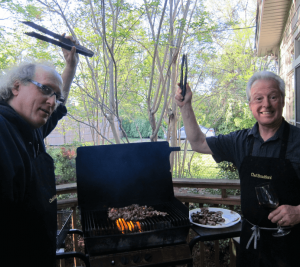 Pictured: Bruce Barry (left) and Jim Bradford (right) grilling. Bradford is seen wearing one of his iconic aprons with "Chef Bradford" monogrammed.