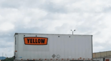 This image shows a Yellow Corp. truck parked in a parking lot.