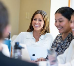 Pictured: Three Vanderbilt Master of Marketing students gather around a computer in a classroom