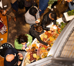Pictured: In a photo taken from above, event guests graze an impressive charcuterie board.