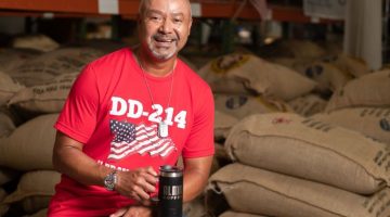 Pictured: Executive MBA alum Al Lopez in his coffee warehouse