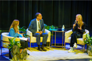 Pictured: Gwyneth Paltrow holds a microphone to speak alongside Vanderbilt faculty members Kelly Goldsmith and David A. Owens.