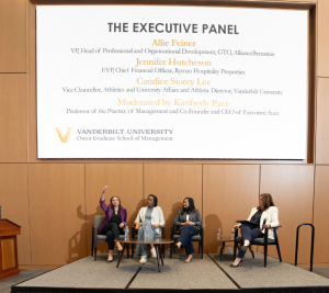 Pictured: In a pictures of the stage and screen above the stage, the panelists are shown in their chairs alongside Pace, the panel moderator. From left to right: Feiner, Lee, Kimberly Pace, the panel moderator. From left to right: Feiner, Lee, Hutcheson, and Pace.