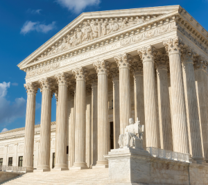 Pictured: With a blue sky as the background, the United States Supreme Court building is displayed. 