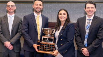 Pictured: Posing with the trophy, the winning team of the 2024 SEC MBA Case Competitionis shown. From left to right: Robert Rickard, Andrew Winter, Monica Traniello, and Zachary Terry.