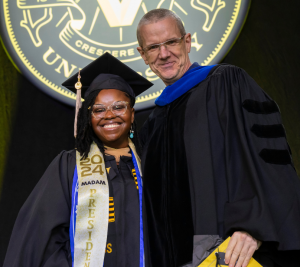 Pictured: Evelyn Ward (MBA'24) and Brian T. McCann pose at the Vanderbilt Business 2024 Commencement.