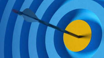 Pictured: A target that shows blue layers with a dart through the center landing.