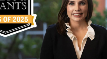 Pictured: Megan Manno, Vanderbilt Business, with the Poets & Quants Class of 2025 banner.