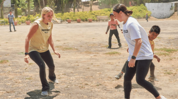 Pictured: Two Vanderbilt Student-Athletes play soccer with Guatemalan children.