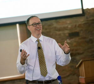 Pictured: Josh White is standing at the front of a classroom teaching a group of students at Vanderbilt Business. White recently used the Reddit IPO case to engage students in real financial topics outside the classroom.