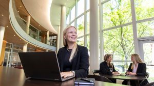 Vanderbilt MS Finance student Celina Sattlekau working in the lobby of Vanderbilt Business