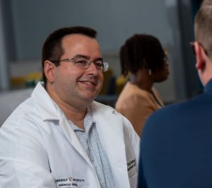 Pictured: Vanderbilt Master of Management in Healthcare student wears white coat