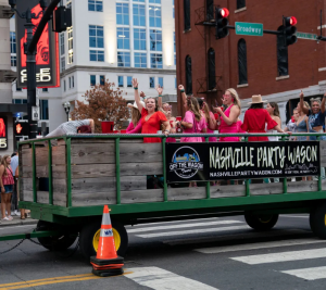 Pictured: people ride on a party wagon on Lower Broadway, photo by Andrew Nelles
