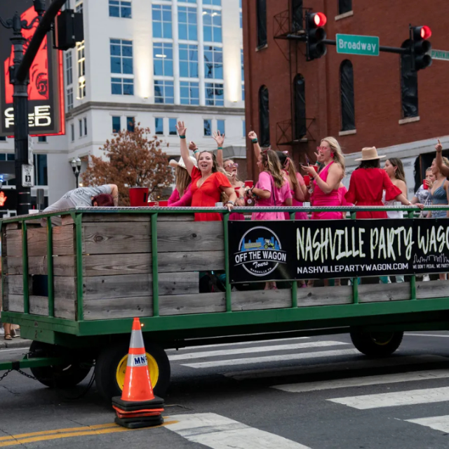 Pictured: people ride on a party wagon on Lower Broadway, photo by Andrew Nelles