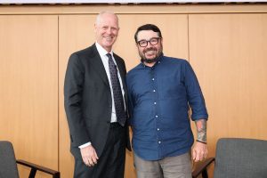 Pictured: Vanderbilt Business Dean Steenburgh (left) and Chef Sean Brock (right) stand together and smile at the camera at a Vanderbilt Business Distinguished Speaker Series event.