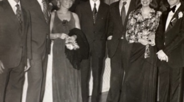 Pictured: An old photo featuring a group of people in dress attire. Philipe Gluntz, Vanderbilt Business alum, is shown with his wife.