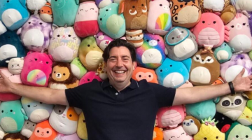 Pictured: Vanderbilt Business alumnus Jeremy Padawer with a wall of Squishmallows