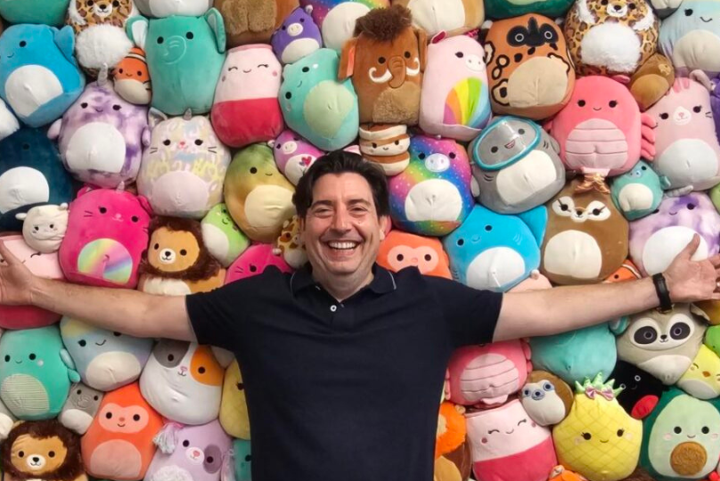 Pictured: Vanderbilt Business alumnus Jeremy Padawer with a wall of Squishmallows