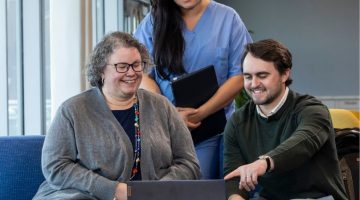 Pictured: Students from the Vanderbilt Master of Management in Health Care Class of 2026 gather around a laptop