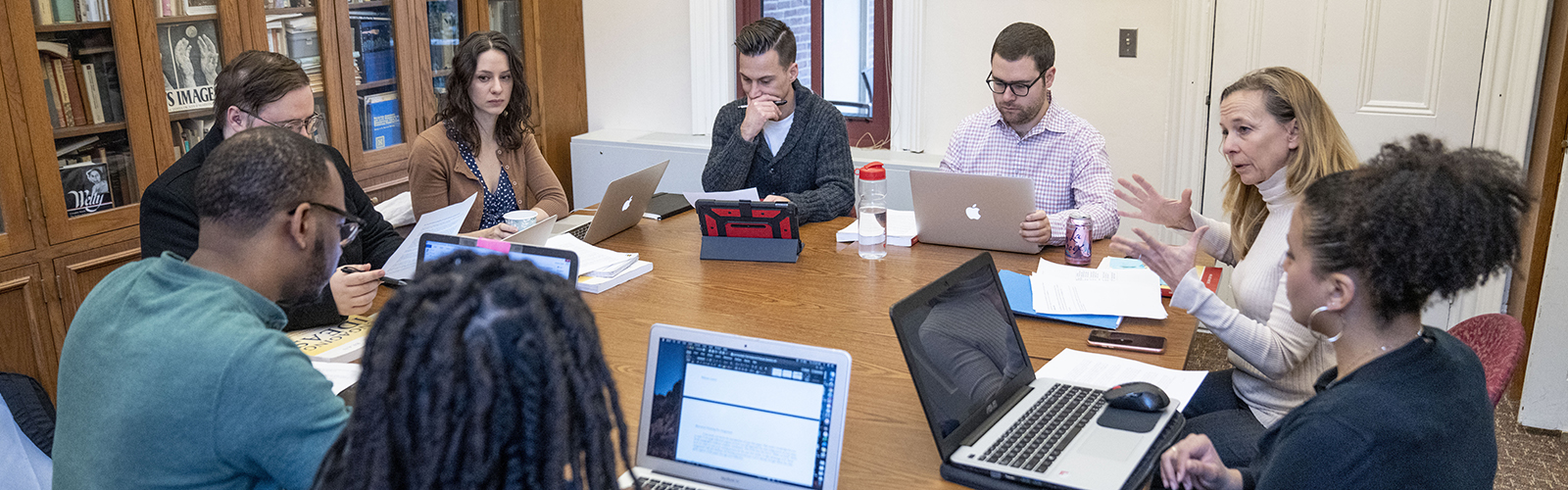 Dana Nelson teaches a graduate English class as students sit around a table in the department library