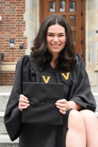 woman smiling in graduation gown