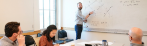 Bradley Smith at a whiteboard teaching Vanderbilt students