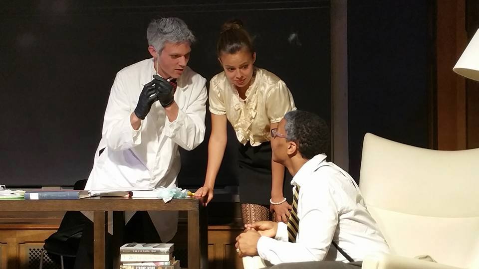 Three students acting in a play.