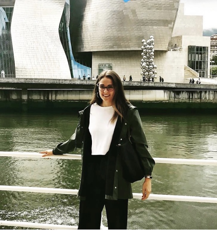 Smiling woman posing in front of a waterway.
