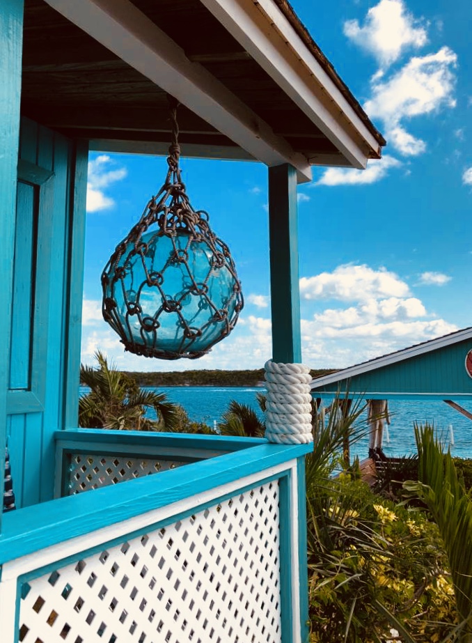 Looking out from a porch onto a blue sea