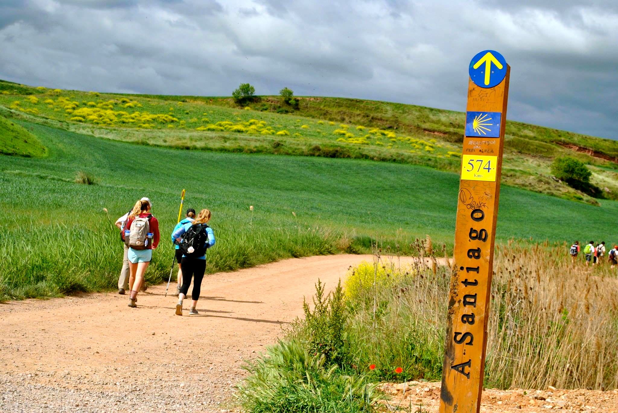 Four students backpacking on a trail in Spain.