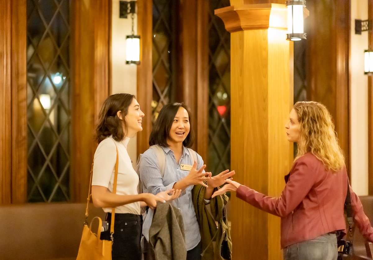 three women standing and talking