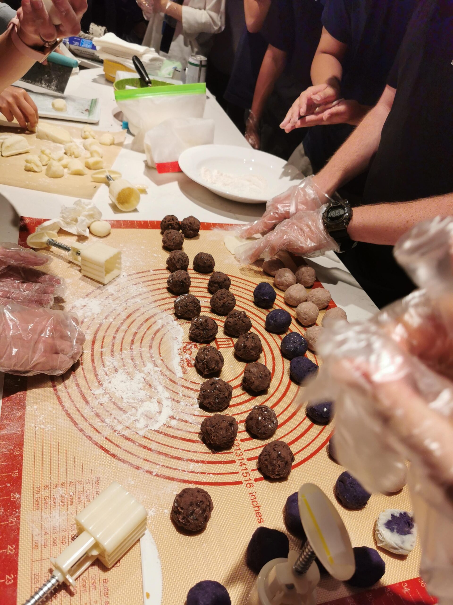 Students Making Mooncakes rolling pounded rice dough into balls