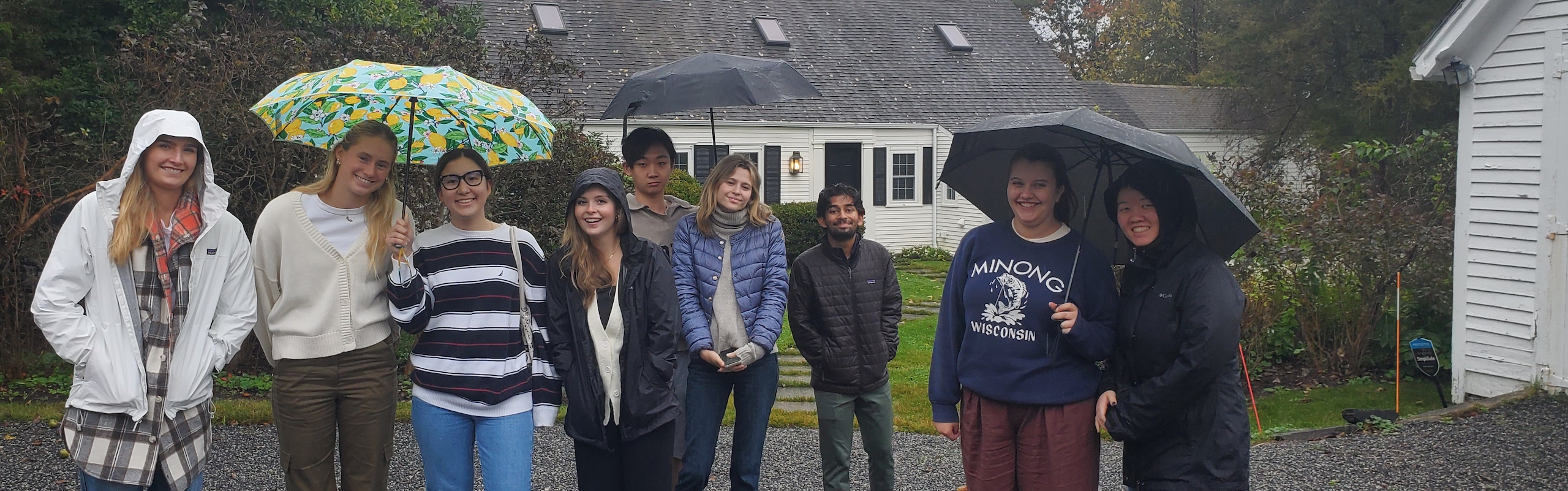 Students standing in the rain on immersion trip in Maine