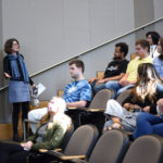 Prof Fay stands and addresses a seated group in a lecture hall