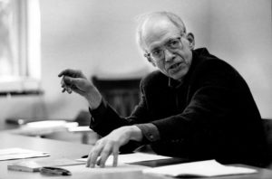 Professor Emeritus George W. Stocking sitting at conference table