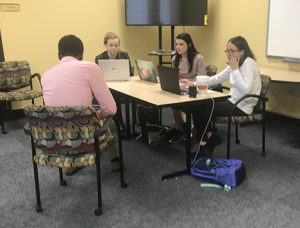 Just City Program Assistant Erin Pounders (right) with Brooke Bowerman ’22 (center back), Jennifer King ’21 (left) and Wesley Dozier ’19 at an expungement clinic held at a local Memphis library.