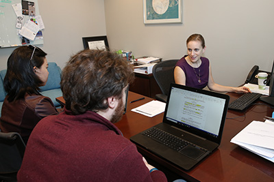 Professor Lauren Rogal meets with students in the Turner Family Community Enterprise Clinic.