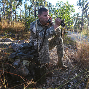 U.S. Army 1st Lt. Matthew Fitzgerald from Bravo Company, 2-27th Infantry, 3rd Brigade, listens to the radio on security watch while his soldiers sleep by a road by a road during Talisman Sabre, Pacific Pathways 2015 at Shoalwater Bay Training Area near Rockhampton, Australia, July 8, 2015. Talisman Sabre is a biennial exercise that provides an invaluable opportunity for nearly 30,000 U.S. and Australian defense forces to conduct operations in a combined, joint and interagency environment that will increase both countries’ ability to plan and execute a full range of operations from combat missions to humanitarian assistance efforts. (U.S. Army Photo by Spc. Michael Sharp/Released)