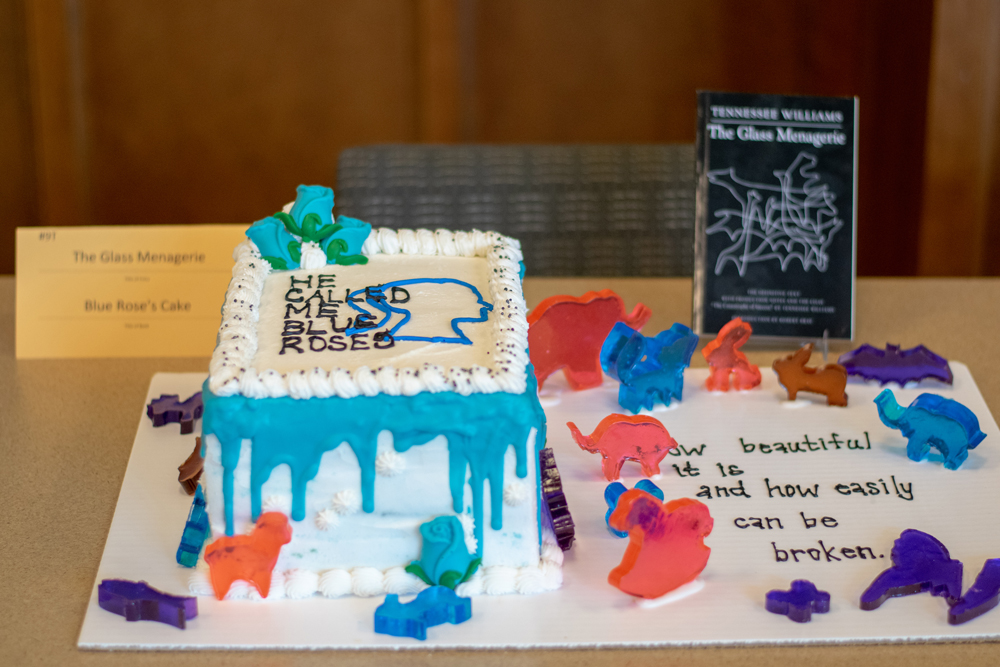 A white cake with blue icing and the quote 