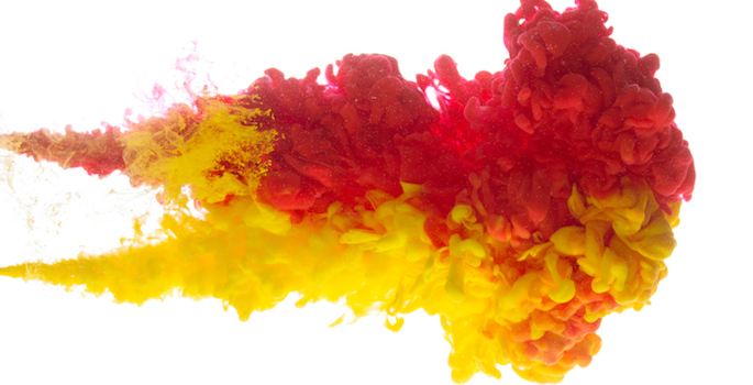 Acrylic yellow and red colorful ink in water abstract isolated on white background