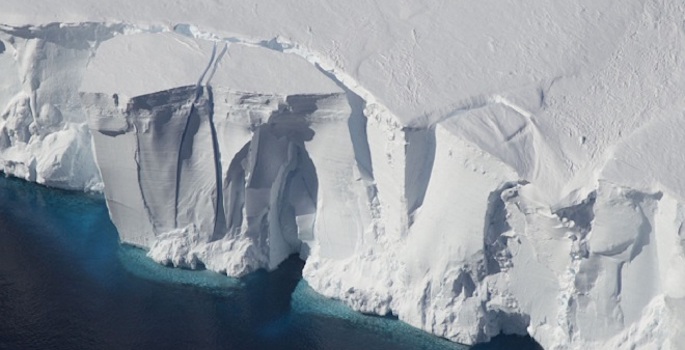 satellite image of antarctic ice sheet fracturing at the edge of the sea