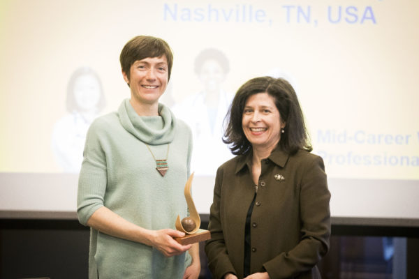 Jessica Dennis, postdoctoral fellow in the Division of Genetic Medicine and research fellow in the Cox Lab accepts the Mary Jane Werthan Award from Women's Center Director Rory Dicker on behalf of Nancy Cox, Director of the Vanderbilt Genetics Institute and Mary Phillips Edmonds Gray Professor of Genetics. (Susan Urmy/Vanderbilt) 