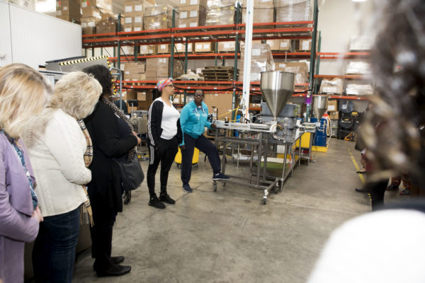 Chancellor's Charter participants touring the production facility at Thistle Farms and hearing the personal narratives of individuals working there. (Susan Urmy/Vanderbilt) <br /> <br />