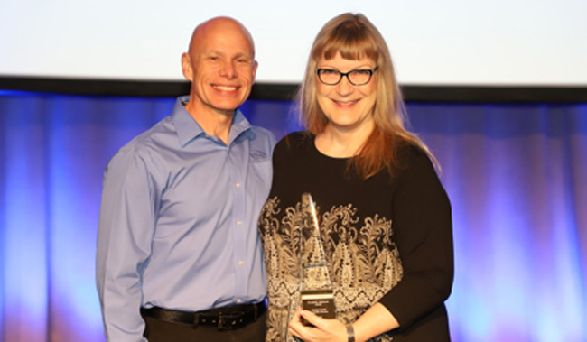 Barbara Carroll (right) receives the Donald E. Dickason Award from Andy Brantley, CEO of CUPA-HR.