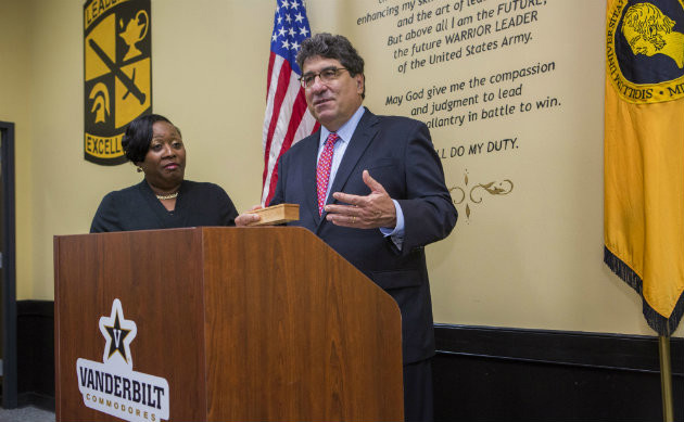 Sandra Bell, human resources technician for Vanderbilt's Army ROTC, receives the Heart and Soul Staff Appreciation Award from Chancellor Nicholas S. Zeppos. (Anne Rayner/Vanderbilt)