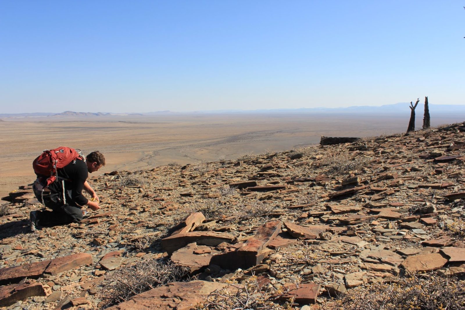 Simon kneeling in the desert